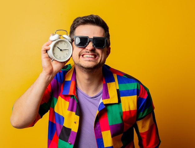 Style guy in 90s shirt with alarm clock