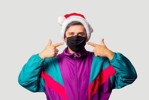 Style guy in Christmas hat and face mask
