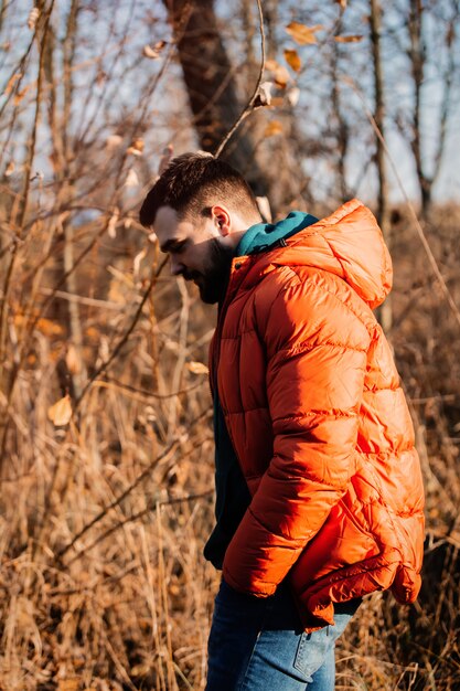 Style man in down jacket at rural autumn outdoor