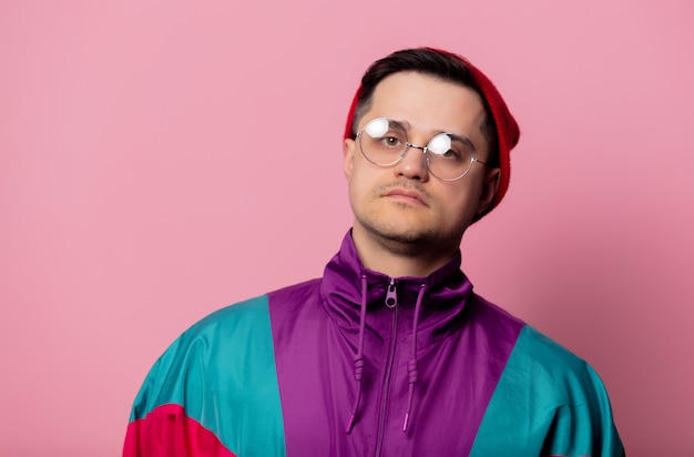 Style man in glasses on pink wall