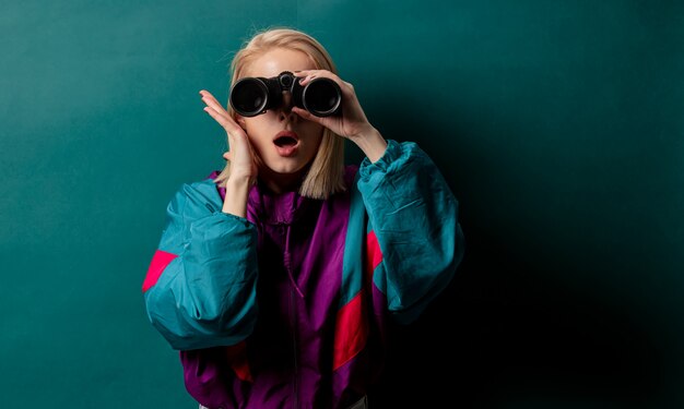 Style woman in 90s punk clothes with binoculars