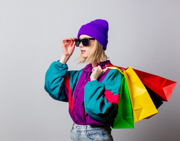 Style woman in 90s punk clothes with shopping bags