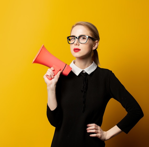 Style woman in black formal clothes with megaphone