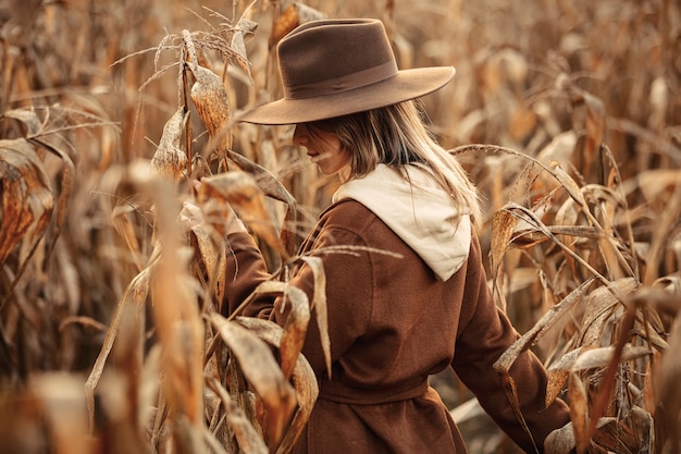 Style woman on corn field in autumn time season