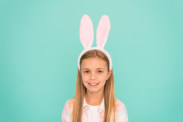 Styling in her Sundays best. Cute little girl wearing bunny ears headband. Small girl child in easter bunny style. Fashion accessory for easter costume party. Looking pretty in easter bunny attire.