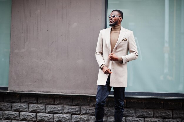 Stylish african american man wear beige jacket with sunglasses