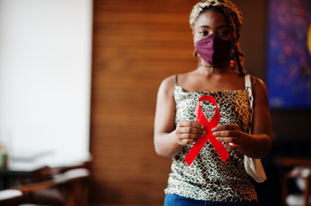 Stylish african american woman hold red ribbon