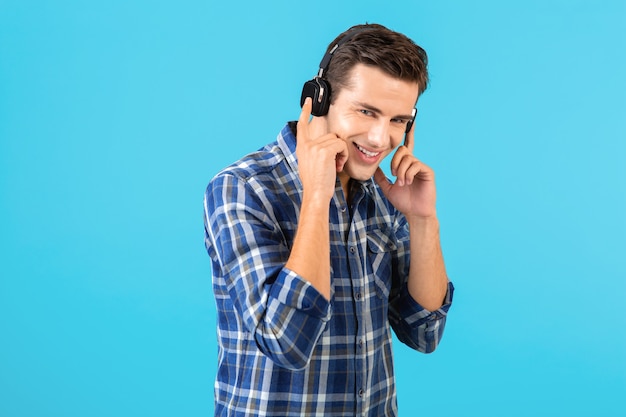 stylish attractive handsome young man listening to music on wireless headphones 