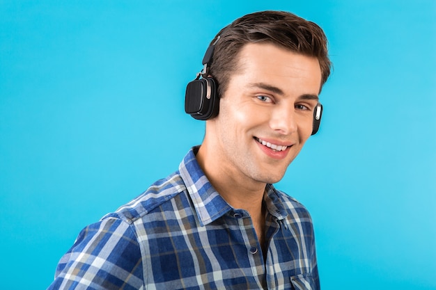 stylish attractive handsome young man listening to music on wireless headphones 