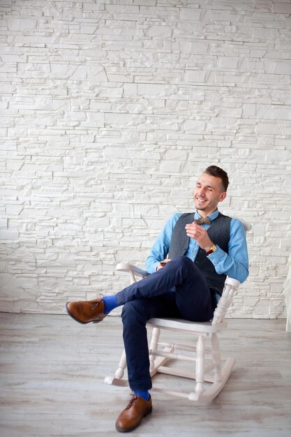 Stylish attractive man sitting in a chair
