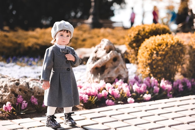 Stylish baby girl 12 year old wearing fresnch style jacket and beret outdoors Spring season