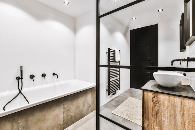 Stylish bathroom with oval sink and mirror in black frame