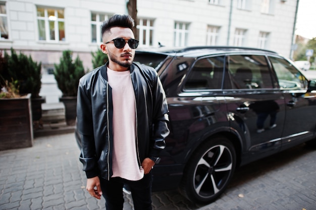 Stylish beard man at black leather jacket and sunglasses