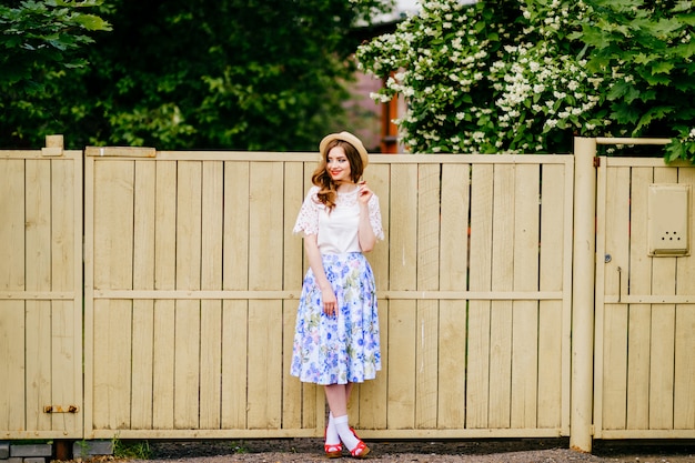 Stylish beautiful girl near the fence