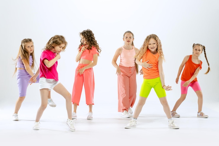 Photo stylish beautiful girls children dancing training having fun isolated over white studio background