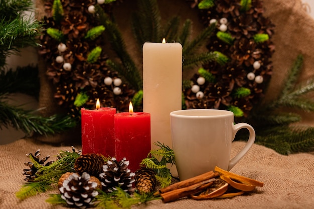 Stylish beautiful New Years composition of cones spruce and candles