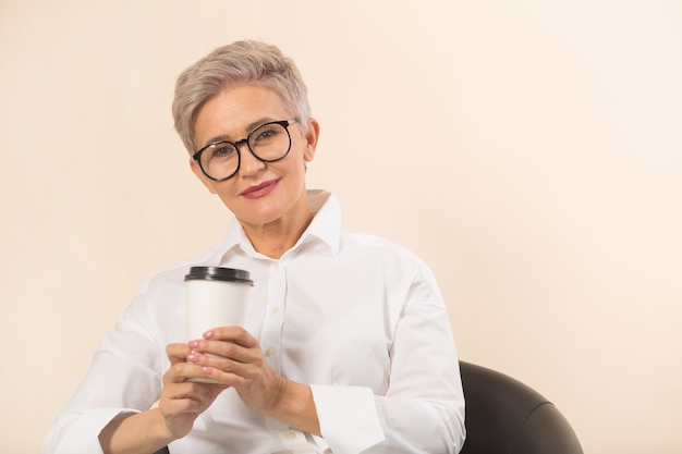 Stylish beautiful woman on a beige background