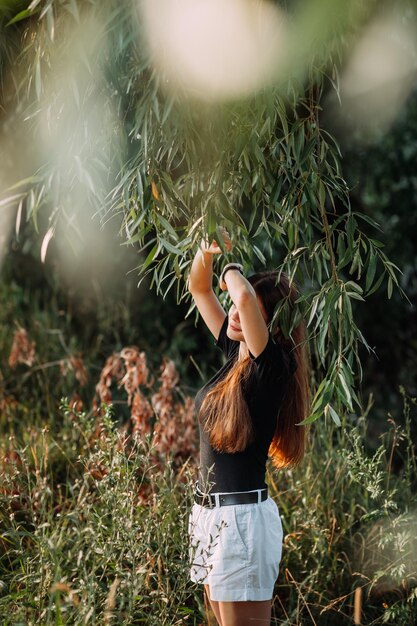 A stylish beauty in a black Tshirt on the shore of a pond 3654