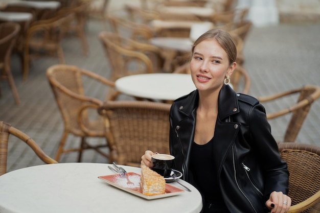 Stylish black leather jacket hair pulled back cheerful\
beautiful young woman of