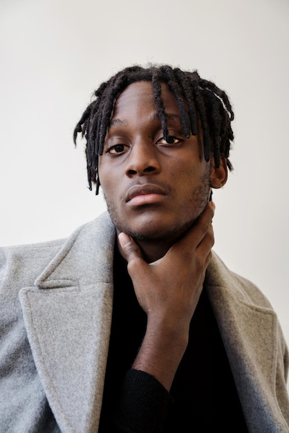 stylish black man wearing coat portrait