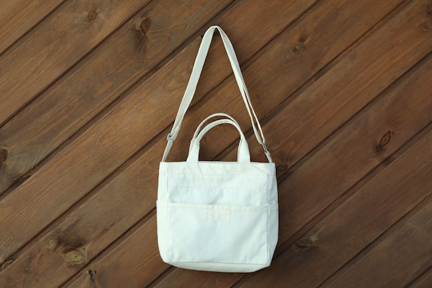 Stylish blank eco bag on wooden surface