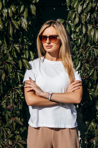 Stylish blonde girl wearing white t-shirt and glasses