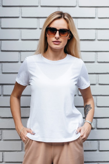 Стильная блондинка в белой футболке и очках