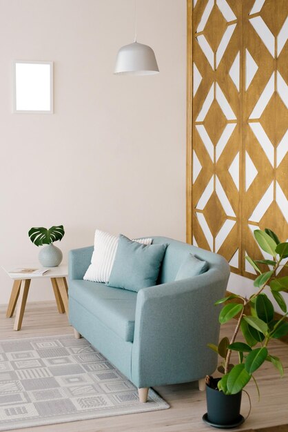 Stylish blue sofa with pillows coffee table ficus in a vase in the living room carpet