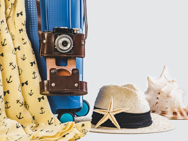 stylish, blue suitcase, sun hat and vintage camera