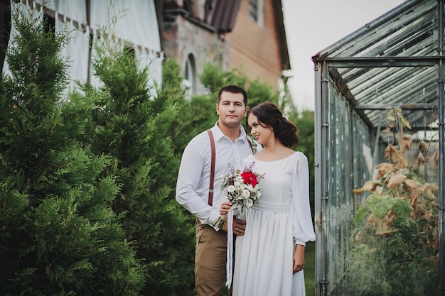 Stylish bride and groom embrace