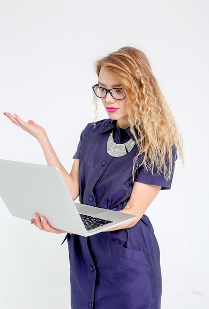 Stylish business woman in a suit with glasses and a laptop 