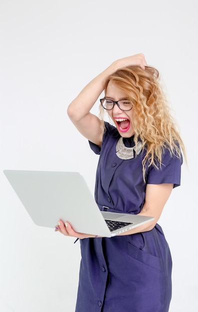 Stylish business woman in a suit with glasses and a laptop