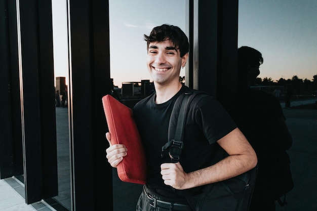 Stylish businessman student on the way to office during a
colourful sunset. business, education,lifestyle concept.serious
model with tshirt.copy space.big building scenery, banking and
administration.