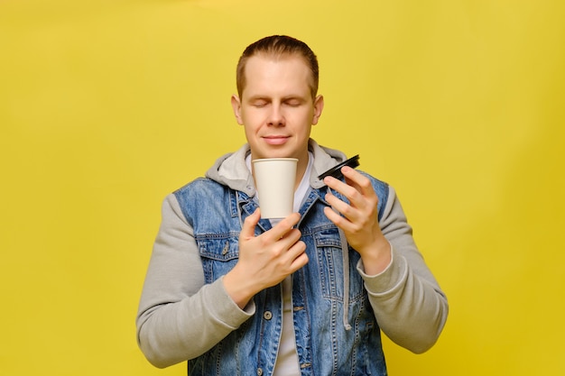 Stylish Caucasian man in jeans on yellow