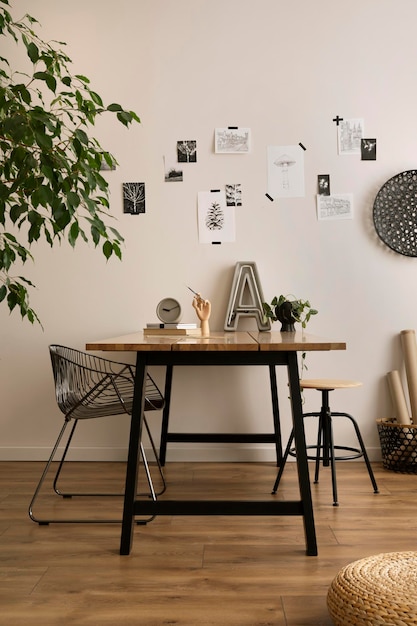 Aesthetic interior of home office interior with design chair, wooden desk,  plants, shelf, office accessories, post cards, photos and decoration.  Minimalist home decor. Template. Photos