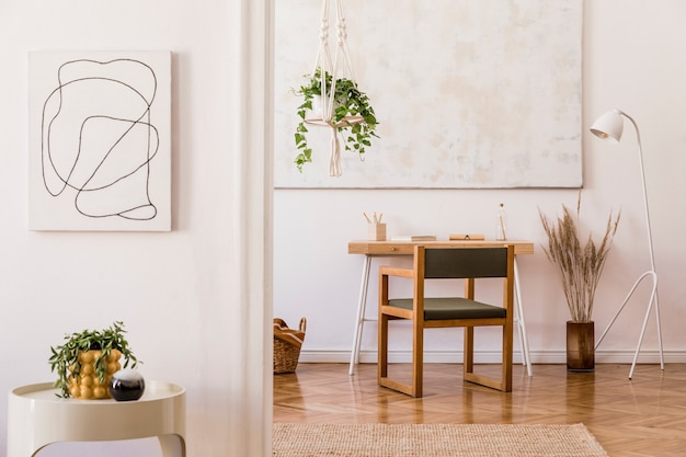 Stylish composition of creative workspace interior with wooden furniture, plants, carpet and accessories. White walls and parquet floor.