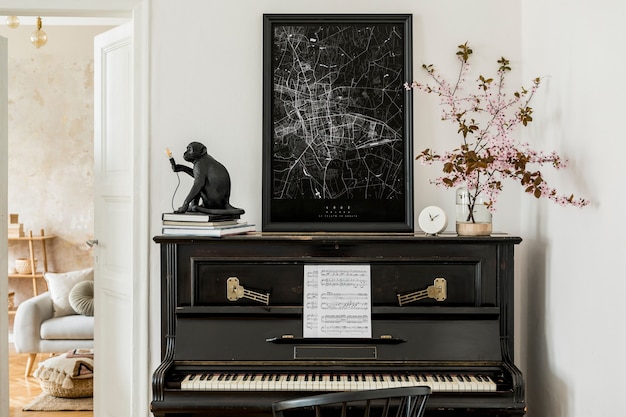 Stylish composition at living room interior with black piano, mock up poster map, dried flowers, white clock, design lamp and elegant presonal accessories in modern home decor.