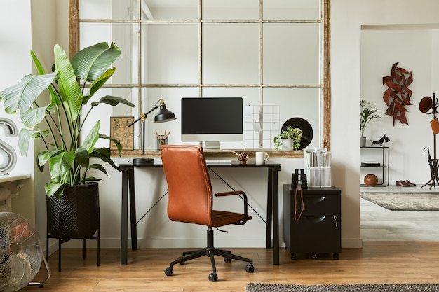 Stylish composition of modern masculine home office workspace\
interior design with black industrial desk, brown leather armchair,\
pc and stylish personal accessories. template.