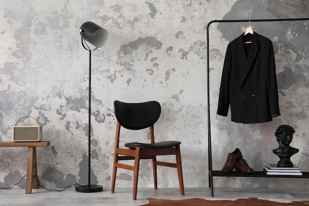 The stylish compostion at living room interior with concrete\
wall chair hanger with clothes and elegant personal accessories\
loft and industrial interior template xd