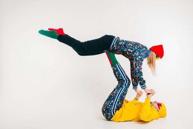 Stylish couple of man and woman in colorful clothes posing