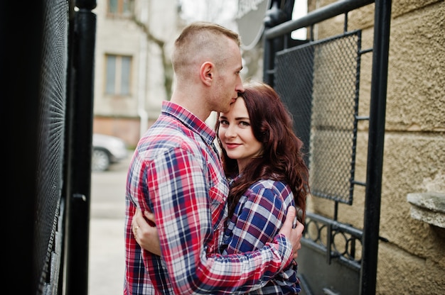 Stylish couple wear on checkered shirt in love together