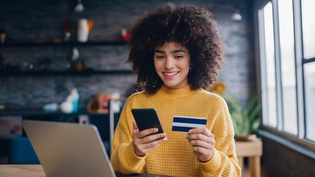 Stylish curly haired girl shopping online using credit card and smartphone