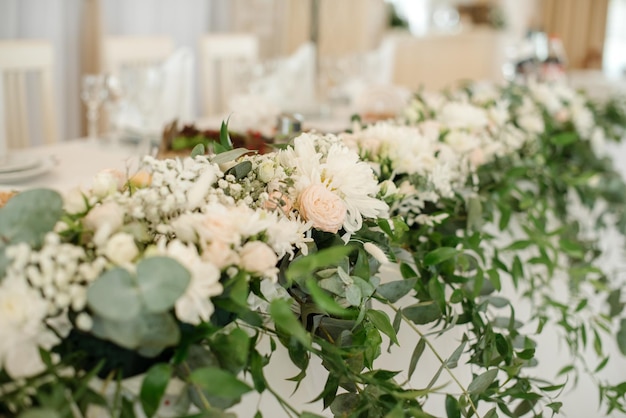 Stylish decorated wedding tables with flowers