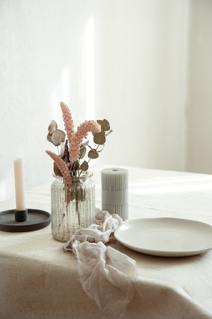 Photo stylish details of the interior decor against the background of a white wall with sunbeams.