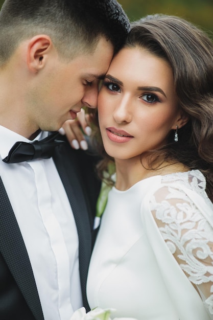 Stylish European wedding at sunset. Happy couple in the forest in nature.