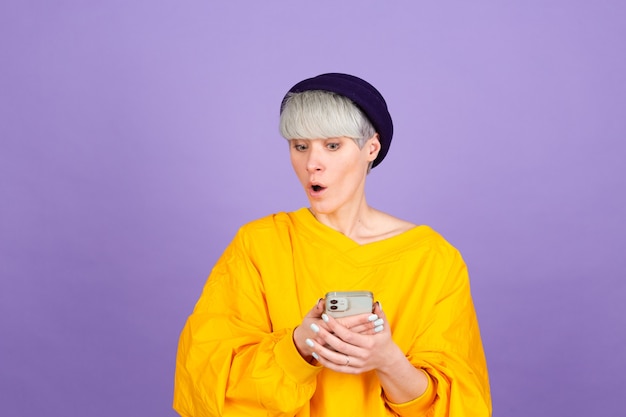 Stylish european woman on purple wall