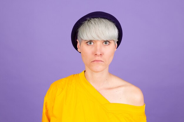 Stylish european woman on purple wall