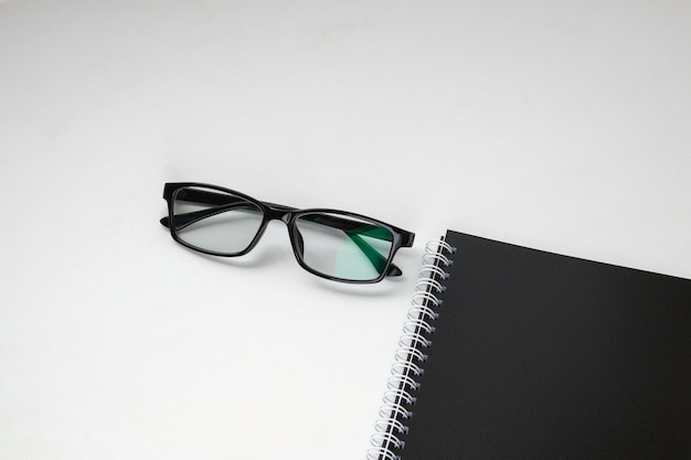 Stylish eyeglasses on white office desk white work desk