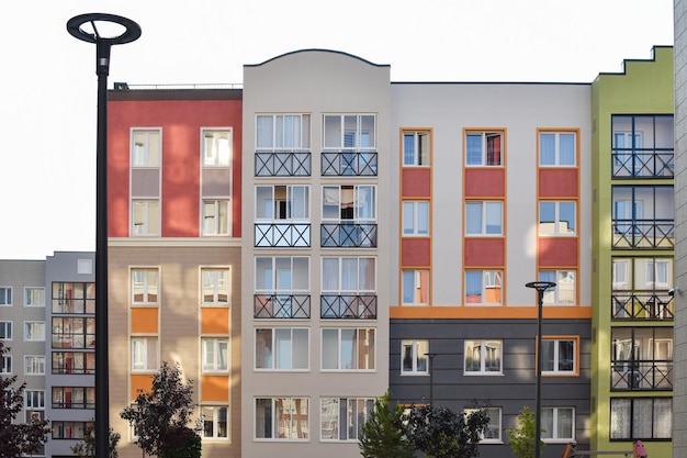 The stylish facade of a residential building with beautiful windows is a new multiapartment residential quarter of European houses