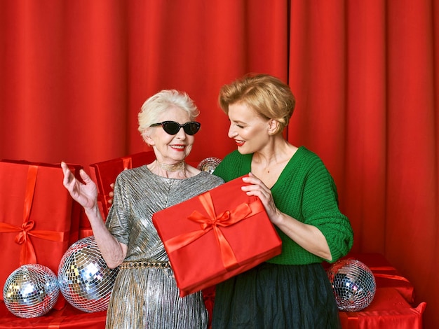 Stylish and fancy senior and mature woman at the party with gift boxes. Party, celebration,